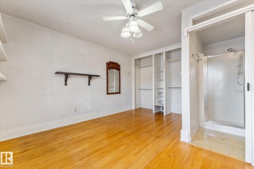 Unfurnished bedroom with light wood-style floors and a ceiling fan - 10921 126 Street, Edmonton, AB - Indoor Photo Showing Other Room