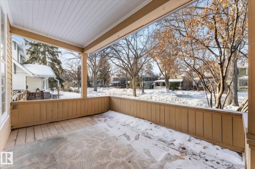 Snow covered patio featuring a residential view and a deck - 10921 126 Street, Edmonton, AB - Outdoor With Deck Patio Veranda