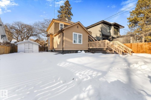 Back of property featuring a fenced backyard, a storage shed, a deck, and stairs - 10921 126 Street, Edmonton, AB - Outdoor