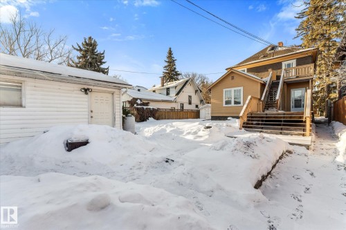 Yard covered in snow featuring stairway and a storage unit - 10921 126 Street, Edmonton, AB - Outdoor