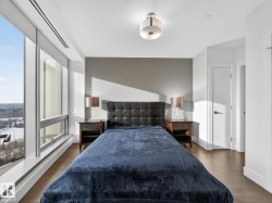 Bedroom featuring dark wood-style floors and baseboards - 