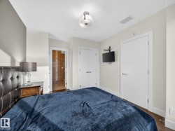 Bedroom featuring dark wood finished floors and a closet - 