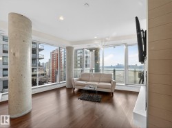 Living area with wood finished floors and recessed lighting - 