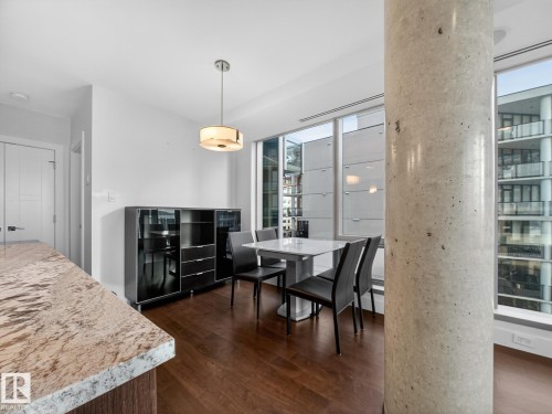 Dining room with dark wood-style floors - 902 11969 Jasper Avenue, Edmonton, AB - Indoor Photo Showing Dining Room