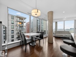 Dining space featuring dark wood-type flooring, a view of city, and recessed lighting - 