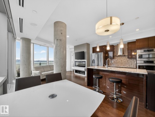 Dining space featuring dark wood-style floors - 902 11969 Jasper Avenue, Edmonton, AB - Indoor Photo Showing Kitchen With Stainless Steel Kitchen With Upgraded Kitchen
