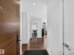 Corridor featuring baseboards and dark wood-type flooring - 