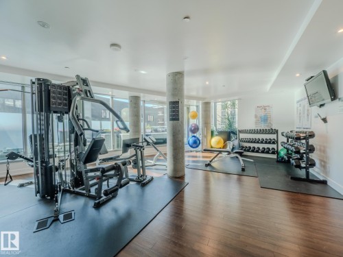 Gym featuring floor to ceiling windows and recessed lighting - 902 11969 Jasper Avenue, Edmonton, AB - Indoor Photo Showing Gym Room