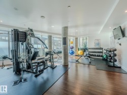 Gym featuring floor to ceiling windows and recessed lighting - 