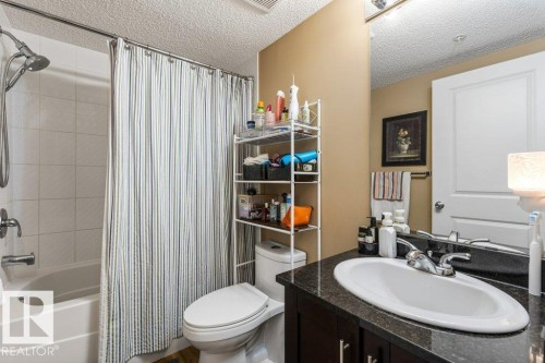Bathroom featuring shower / tub combo with curtain, vanity, and a textured ceiling - 107 25 Element Dr, St. Albert, AB - Indoor Photo Showing Bathroom