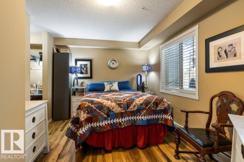 Bedroom with light wood-style flooring and a textured ceiling - 107 25 Element Dr, St. Albert, AB - Indoor Photo Showing Bedroom