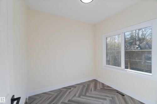 Main floor bedroom with window 8'4" x 9' - 8319 81Ave, Edmonton, AB - Indoor Photo Showing Other Room