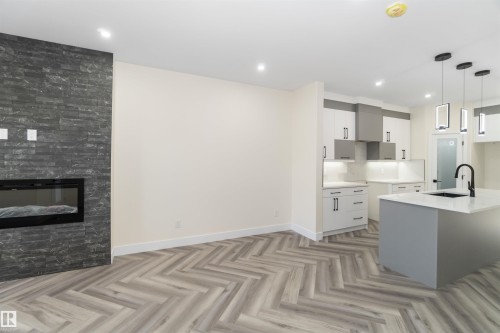 Quartz countertops and high end finishing define the kitchen - 8319 81Ave, Edmonton, AB - Indoor Photo Showing Kitchen With Upgraded Kitchen
