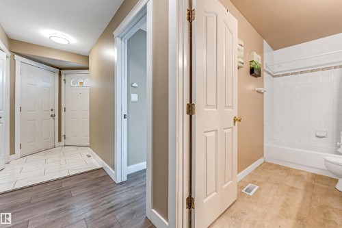 Bathroom with bathtub / shower combination and light wood finished floors - 6741 162A Avenue, Edmonton, AB - Indoor