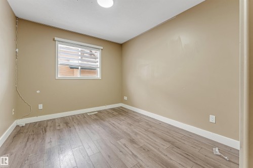 Empty room featuring baseboards and light wood-type flooring - 6741 162A Avenue, Edmonton, AB - Indoor Photo Showing Other Room