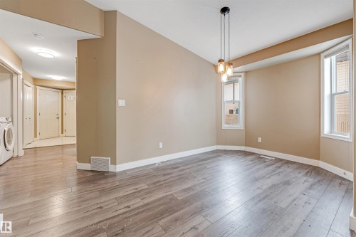 Spare room featuring light wood finished floors and washer / dryer - 6741 162A Avenue, Edmonton, AB - Indoor Photo Showing Other Room