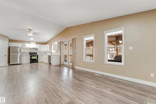Unfurnished living room featuring light wood-style flooring, a ceiling fan, and vaulted ceiling - 6741 162A Avenue, Edmonton, AB - Indoor