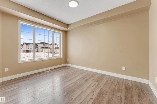 Empty room featuring baseboards and light wood-style floors - 6741 162A Avenue, Edmonton, AB - Indoor Photo Showing Other Room