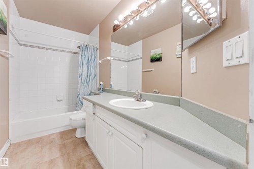 Full bathroom featuring vanity, shower / bath combo, and light tile patterned floors - 6741 162A Avenue, Edmonton, AB - Indoor Photo Showing Bathroom