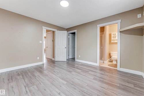 Unfurnished bedroom featuring light wood-style flooring and ensuite bathroom - 6741 162A Avenue, Edmonton, AB - Indoor Photo Showing Other Room