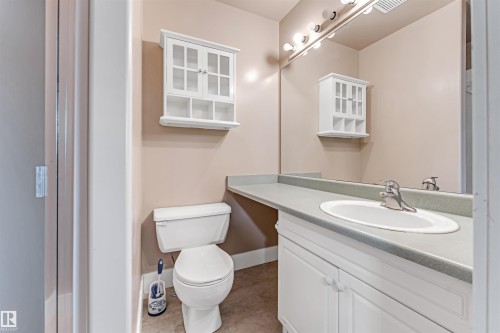 Half bathroom with vanity and light tile patterned floors - 6741 162A Avenue, Edmonton, AB - Indoor Photo Showing Bathroom
