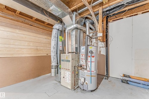 Utilities featuring water heater and heating unit - 6741 162A Avenue, Edmonton, AB - Indoor Photo Showing Basement