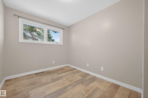 Spare room featuring light wood finished floors and baseboards - 8328 164 Street, Edmonton, AB - Indoor Photo Showing Other Room