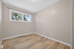 Spare room featuring light wood finished floors and baseboards - 