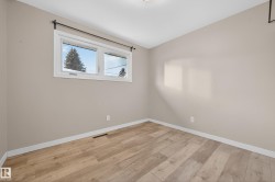 Unfurnished room with light wood-style floors and vaulted ceiling - 