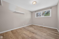 Spare room featuring light wood-style floors and baseboards - 