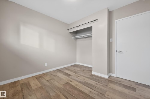 Unfurnished bedroom featuring light wood finished floors and a closet - 8328 164 Street, Edmonton, AB - Indoor Photo Showing Other Room