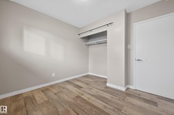 Unfurnished bedroom featuring light wood finished floors and a closet - 