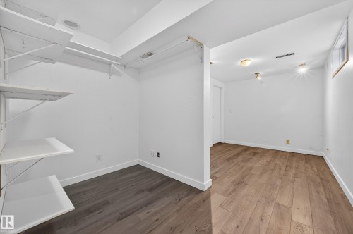 Empty room with wood finished floors and baseboards - 8328 164 Street, Edmonton, AB - Indoor