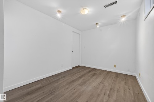 Empty room with baseboards and light wood-type flooring - 8328 164 Street, Edmonton, AB - Indoor Photo Showing Other Room