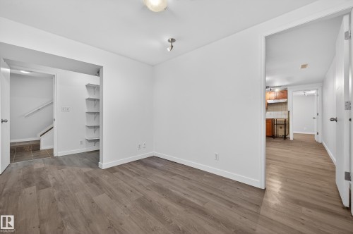 Unfurnished dining area featuring light wood finished floors and baseboards - 8328 164 Street, Edmonton, AB - Indoor Photo Showing Other Room