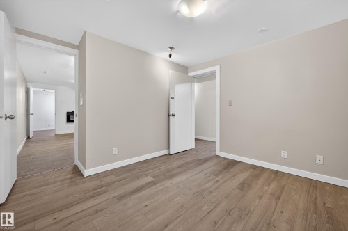 Spare room featuring light wood-type flooring and baseboards - 8328 164 Street, Edmonton, AB - Indoor Photo Showing Other Room