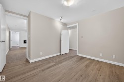 Spare room featuring light wood-type flooring and baseboards - 