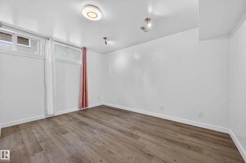 Unfurnished bedroom featuring wood finished floors - 8328 164 Street, Edmonton, AB - Indoor Photo Showing Other Room