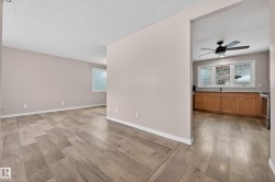 Unfurnished room with a ceiling fan, light wood-style floors, and a textured ceiling - 