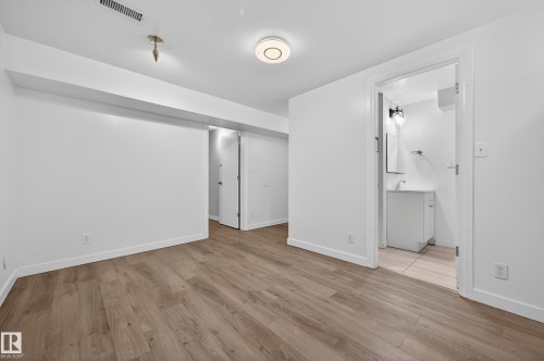 Below grade area with light wood-style flooring - 8328 164 Street, Edmonton, AB - Indoor Photo Showing Other Room