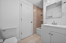 Full bathroom featuring vanity, light tile patterned floors, and washtub / shower combination - 