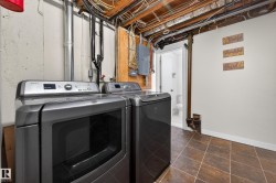 Washroom featuring washing machine and dryer and electric panel - 