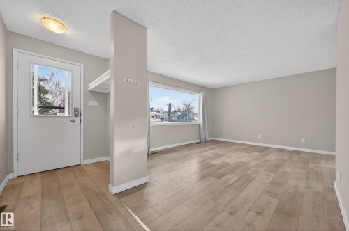 Entrance foyer featuring light wood-style flooring and a textured ceiling - 8328 164 Street, Edmonton, AB - Indoor Photo Showing Other Room