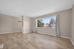 Spare room with light wood-style floors and a textured ceiling - 