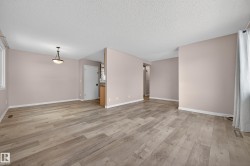 Unfurnished room featuring light wood-style floors and a textured ceiling - 