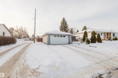Snow covered garage with a garage - 13315 134 Avenue, Edmonton, AB - Outdoor