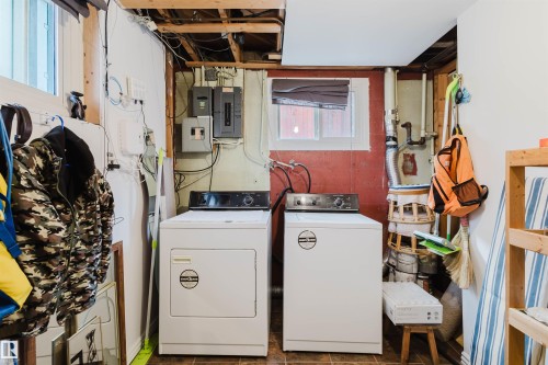 Laundry area with separate washer and dryer and electric panel - 13315 134 Avenue, Edmonton, AB - Indoor Photo Showing Laundry Room