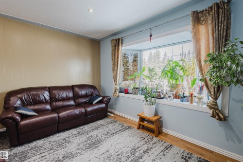 Living area with wood finished floors and baseboards - 13315 134 Avenue, Edmonton, AB - Indoor Photo Showing Living Room