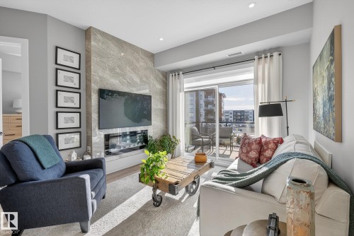 401 7471 May Common, Edmonton, AB - Indoor Photo Showing Living Room With Fireplace