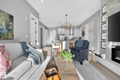 401 7471 May Common, Edmonton, AB - Indoor Photo Showing Living Room With Fireplace